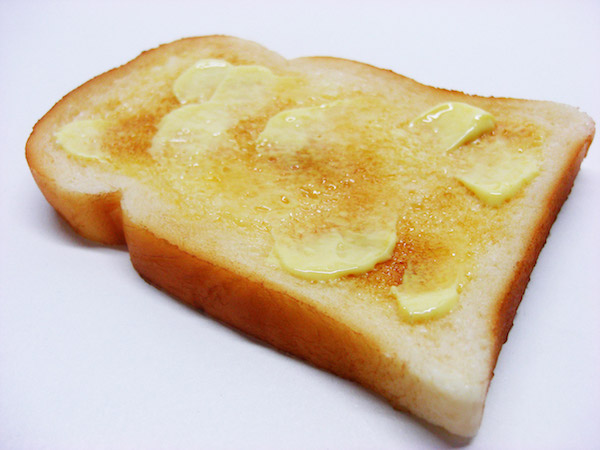 A slice of toast with butter on it.
